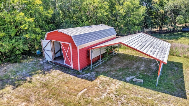 view of outbuilding featuring a lawn and a carport