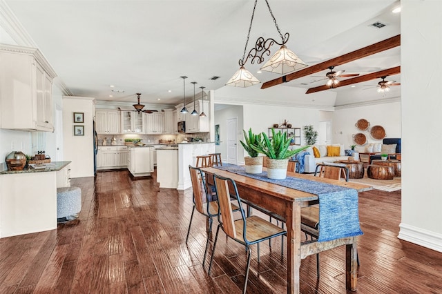 dining area with beamed ceiling, ornamental molding, and dark hardwood / wood-style floors