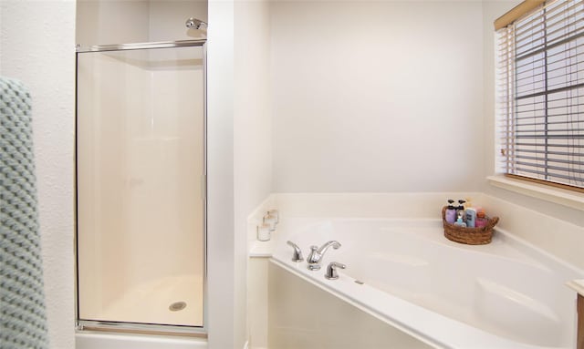 bathroom with shower with separate bathtub