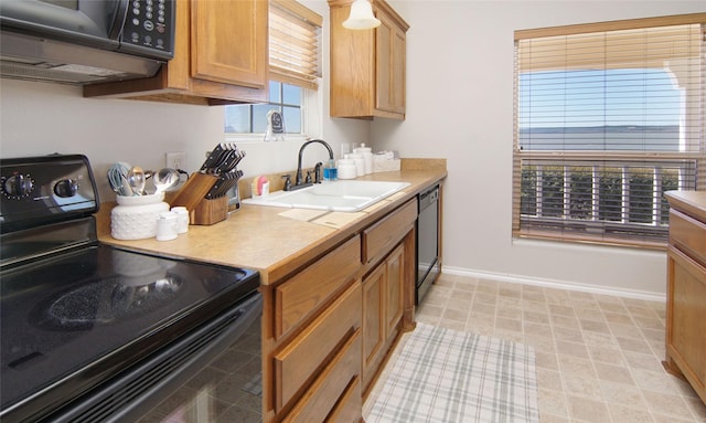 kitchen featuring sink and black appliances