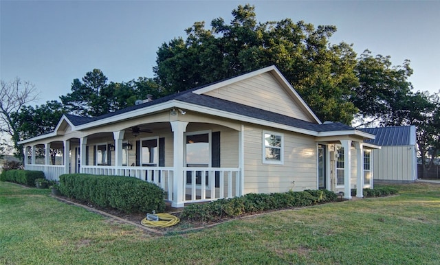 view of side of home featuring a yard and covered porch