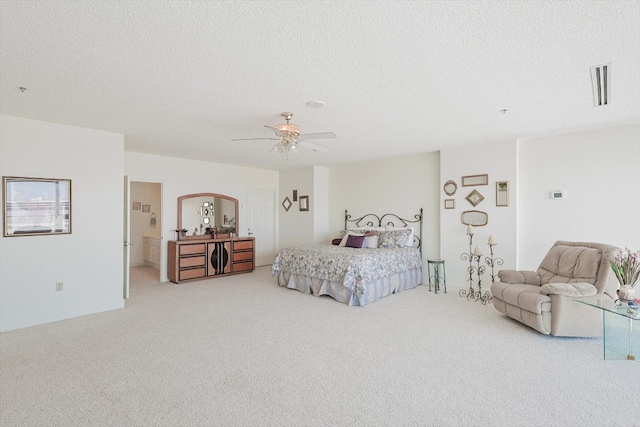 bedroom with ceiling fan, light carpet, and a textured ceiling