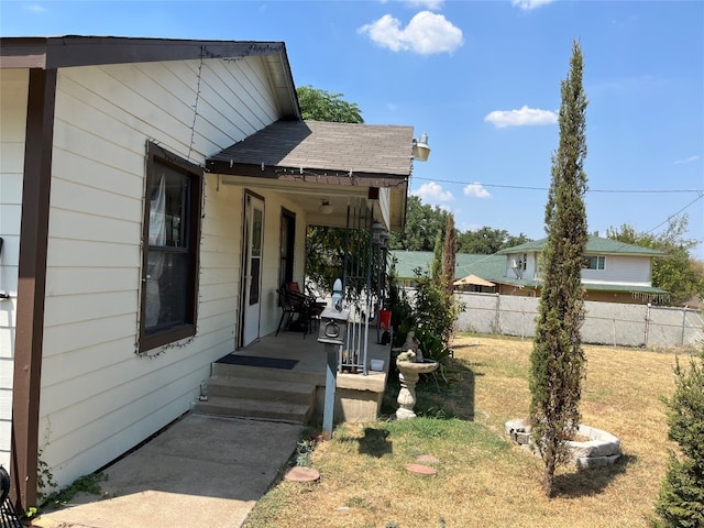 entrance to property featuring a yard