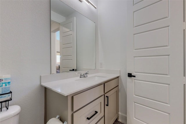 bathroom featuring oversized vanity and toilet