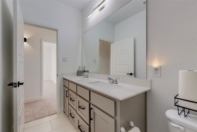 bathroom with large vanity, tile flooring, double sink, and toilet