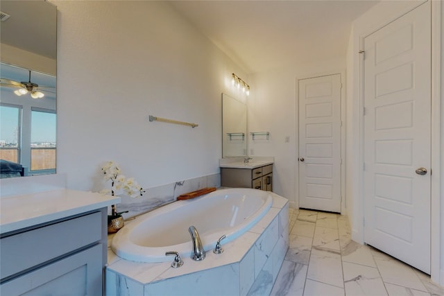 bathroom with tiled bath, tile floors, vanity, and ceiling fan