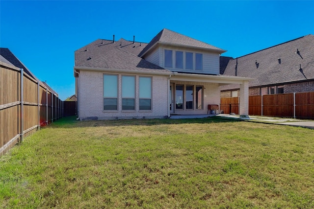 rear view of property with a lawn