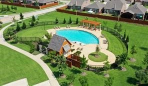 view of swimming pool with a lawn and a patio area