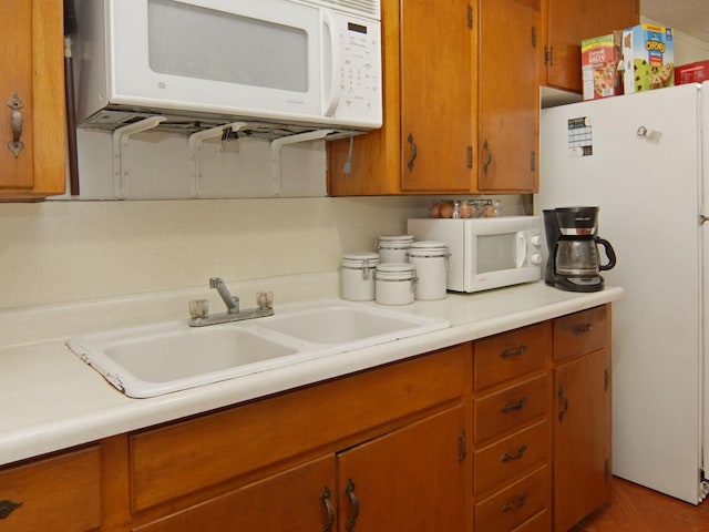 kitchen with white appliances and sink