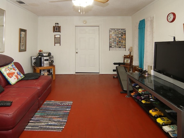 living room with ceiling fan and a textured ceiling