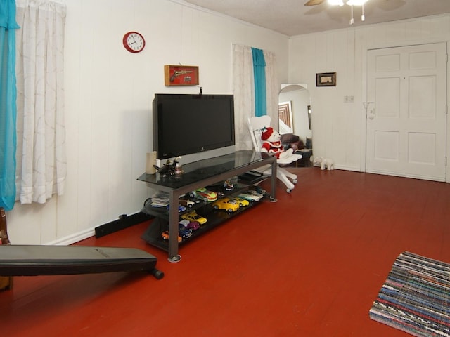 exercise room with ceiling fan, crown molding, and a textured ceiling