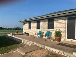 view of side of property with a patio