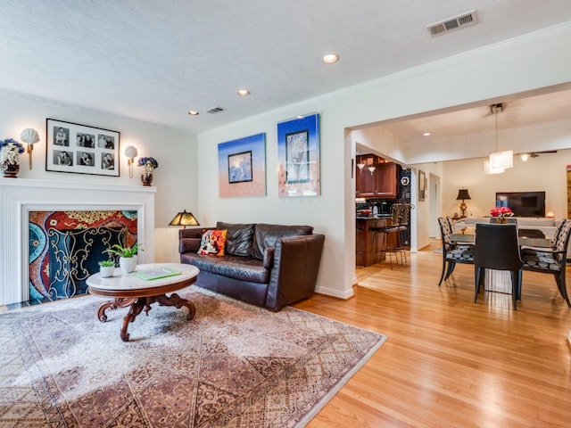 living room featuring light hardwood / wood-style flooring and a textured ceiling