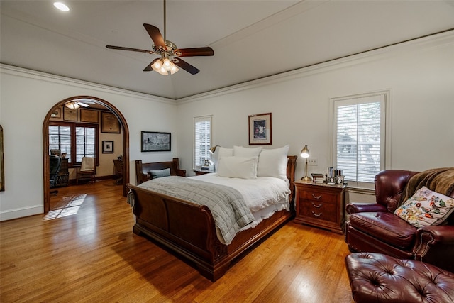 bedroom with light hardwood / wood-style flooring, ceiling fan, and crown molding