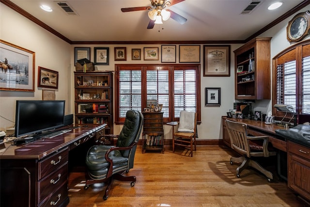 home office with a healthy amount of sunlight, light hardwood / wood-style floors, ceiling fan, and crown molding