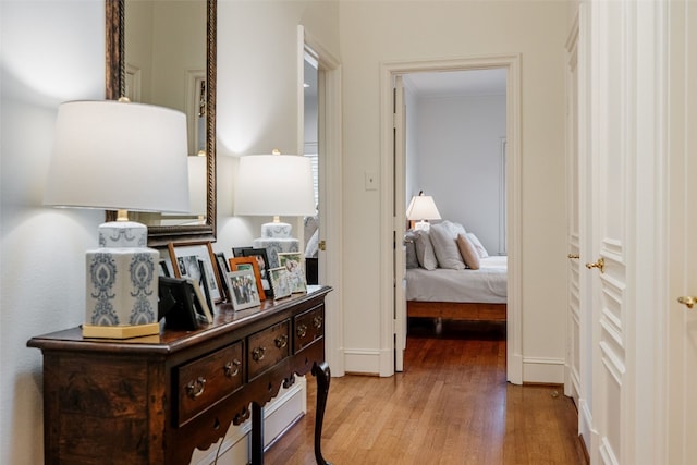 corridor with hardwood / wood-style floors