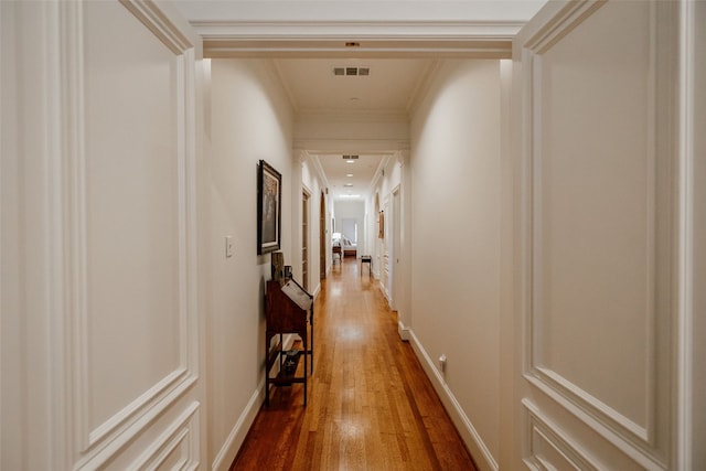 hallway with crown molding and dark hardwood / wood-style floors