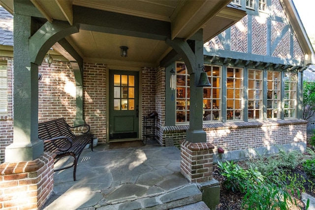 view of exterior entry with a patio area and french doors