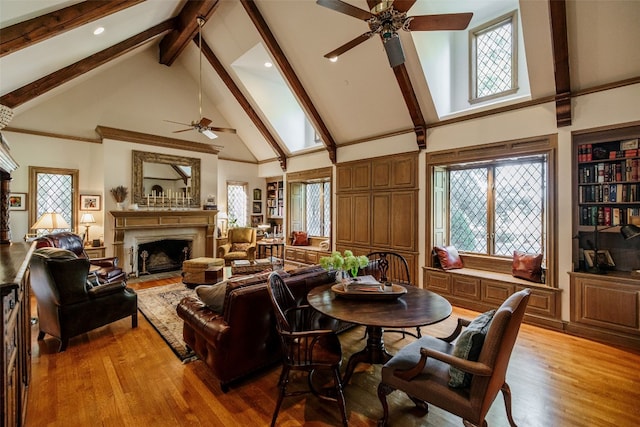 dining area with high vaulted ceiling, a wealth of natural light, ceiling fan, and hardwood / wood-style flooring