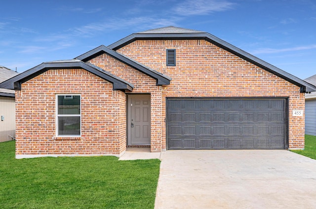 front facade featuring a garage and a front lawn