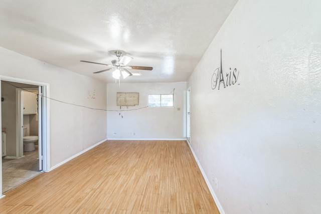 spare room with light wood-type flooring and ceiling fan