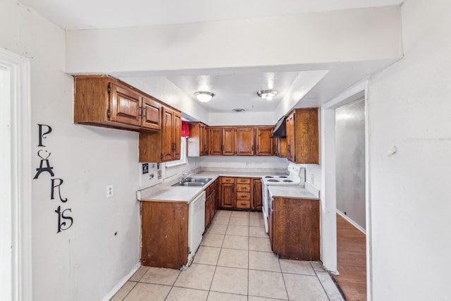 kitchen featuring white appliances, extractor fan, light tile patterned floors, and sink