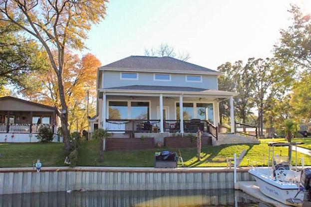 back of property featuring a lawn