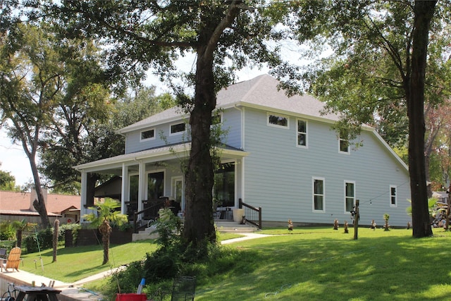 back of property featuring a yard