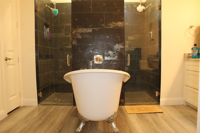 bathroom featuring vanity, separate shower and tub, and hardwood / wood-style floors