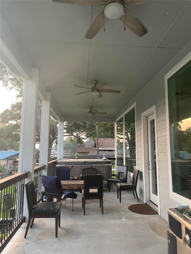 view of patio featuring ceiling fan and a hot tub