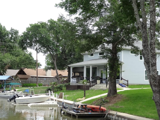 view of dock featuring a yard and a water view