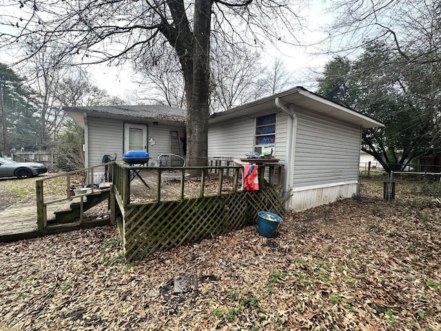 back of house featuring a deck