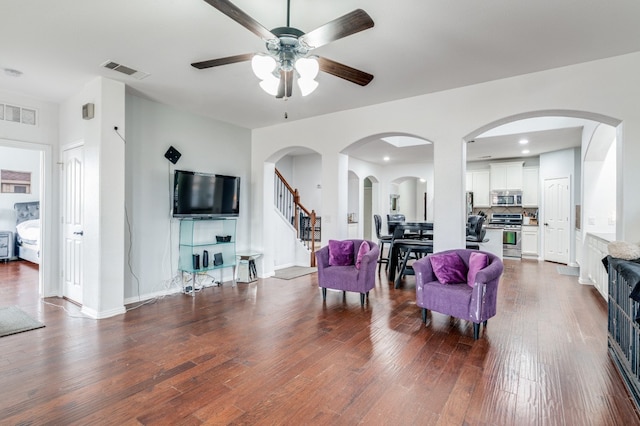 living room featuring dark hardwood / wood-style floors and ceiling fan