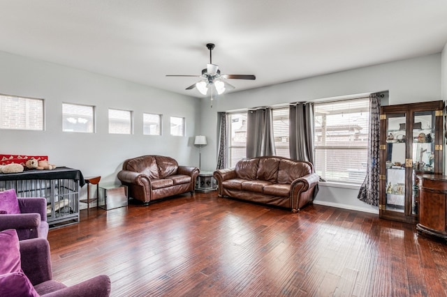 living room with ceiling fan, dark wood-type flooring, and plenty of natural light