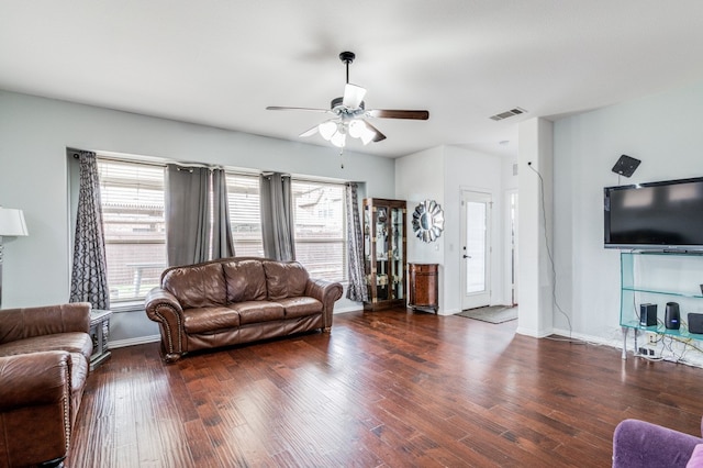 living room featuring ceiling fan and dark hardwood / wood-style flooring