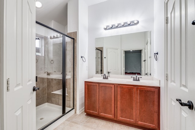 bathroom featuring tile floors, double sink, oversized vanity, and walk in shower