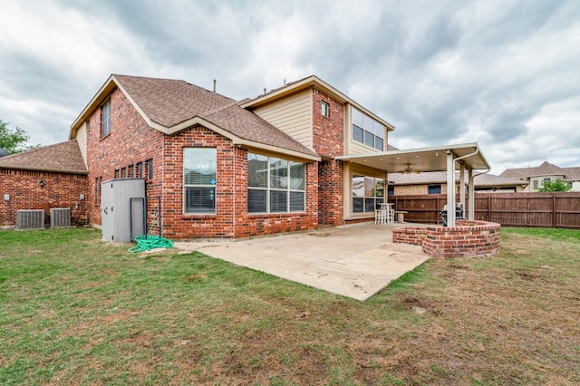 rear view of house featuring a lawn, a patio, ceiling fan, and central air condition unit