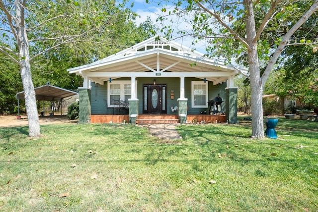 view of front of property with a porch, a carport, and a front lawn