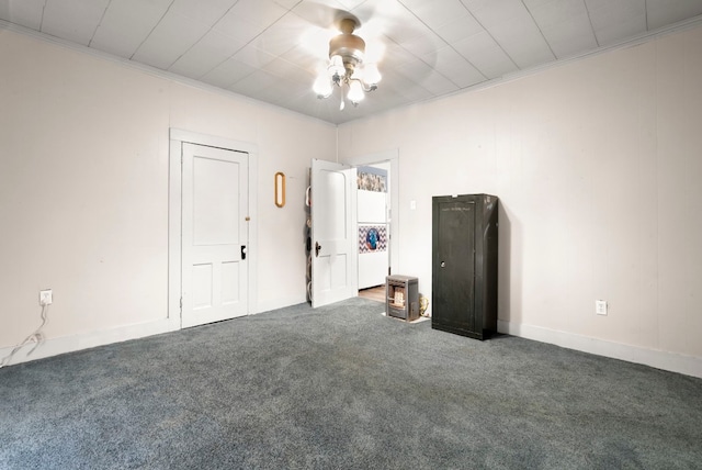 carpeted spare room with ceiling fan and crown molding