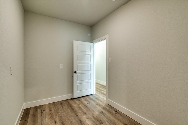 empty room with light hardwood / wood-style flooring