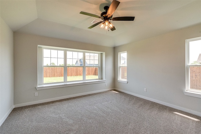 spare room featuring carpet floors, a healthy amount of sunlight, and ceiling fan