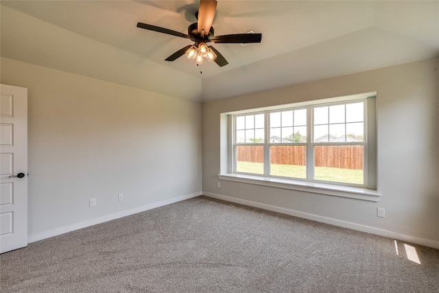 empty room featuring ceiling fan, carpet, and vaulted ceiling