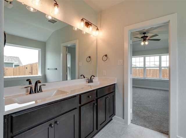 bathroom with double sink, lofted ceiling, ceiling fan, tile flooring, and large vanity