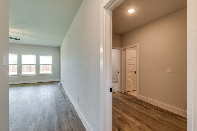 hallway with dark hardwood / wood-style flooring