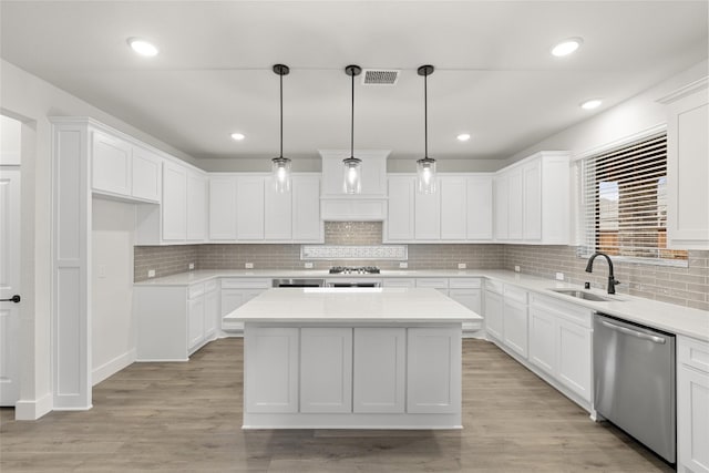 kitchen featuring backsplash, hanging light fixtures, stainless steel appliances, and sink