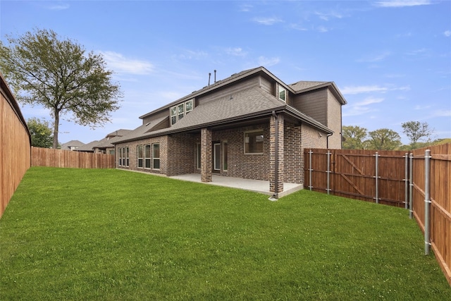 rear view of property featuring a patio area and a lawn