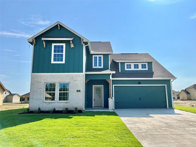 view of front of home with a front yard and a garage