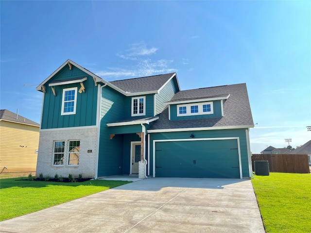 view of front of home featuring a front yard and a garage