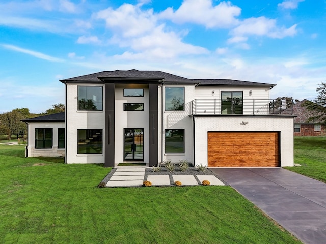 view of front of house with a balcony, a garage, and a front lawn