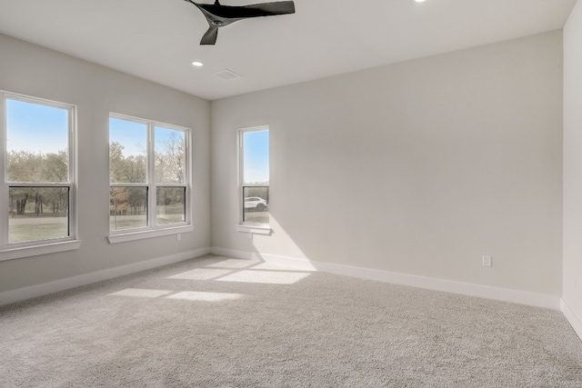 carpeted spare room with ceiling fan